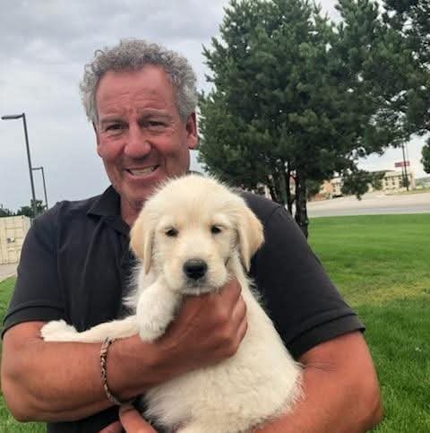 David Singer holding his puppy
